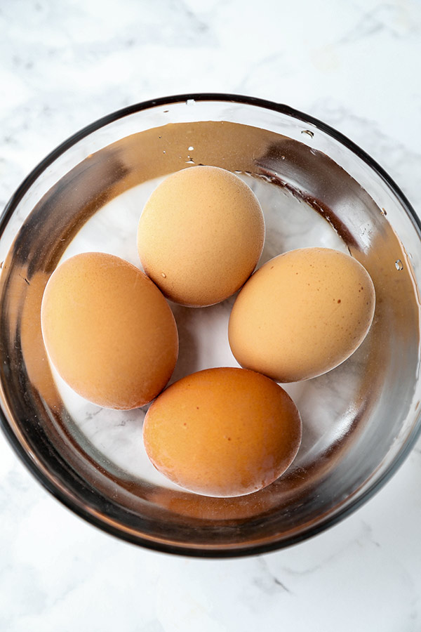 Cooked eggs in ice bath.
