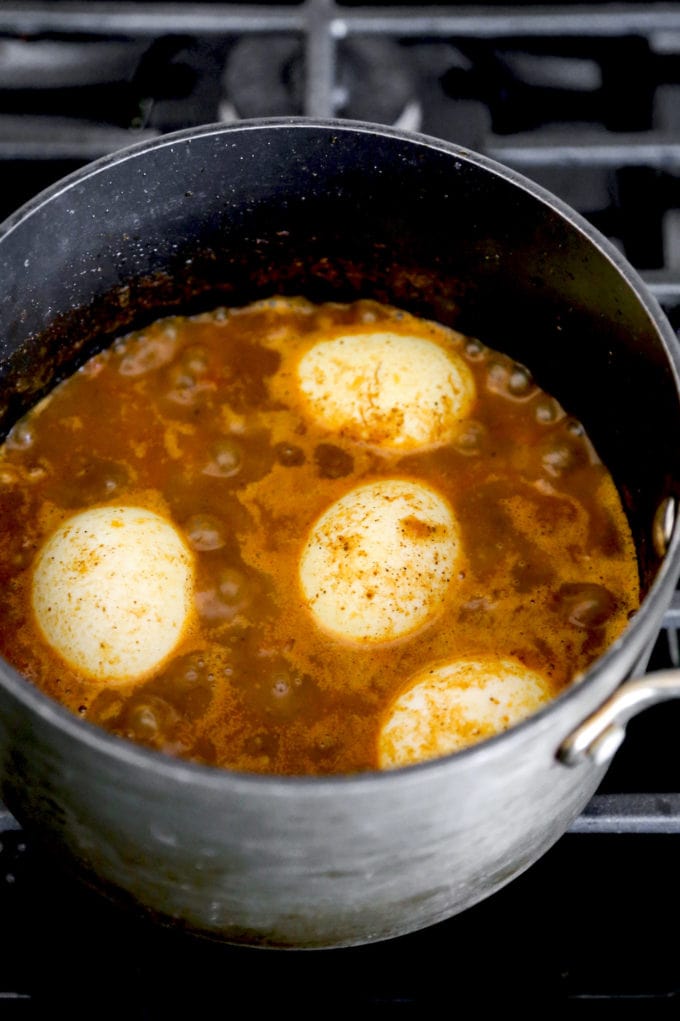 eggs boiling in curry sauce
