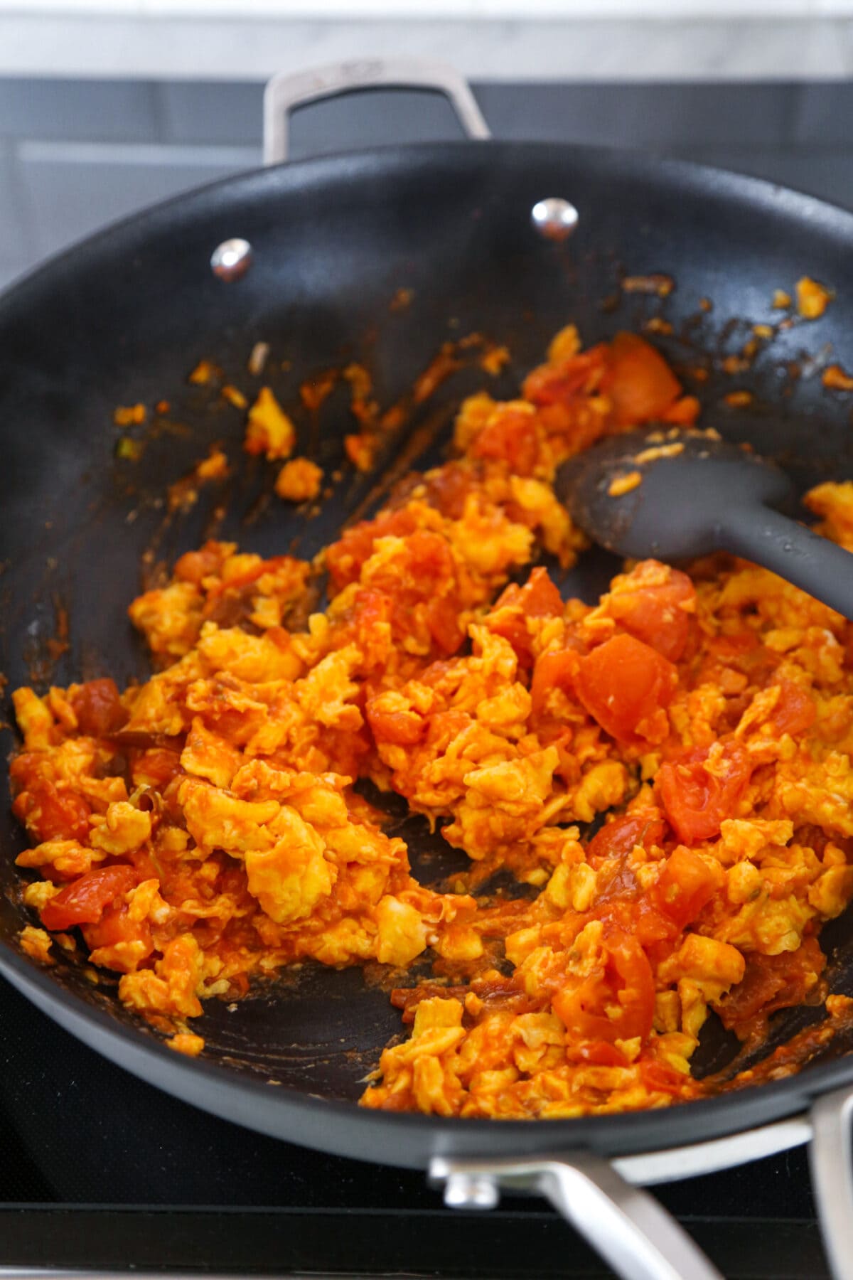 chopped tomato and scrambled egg in skillet