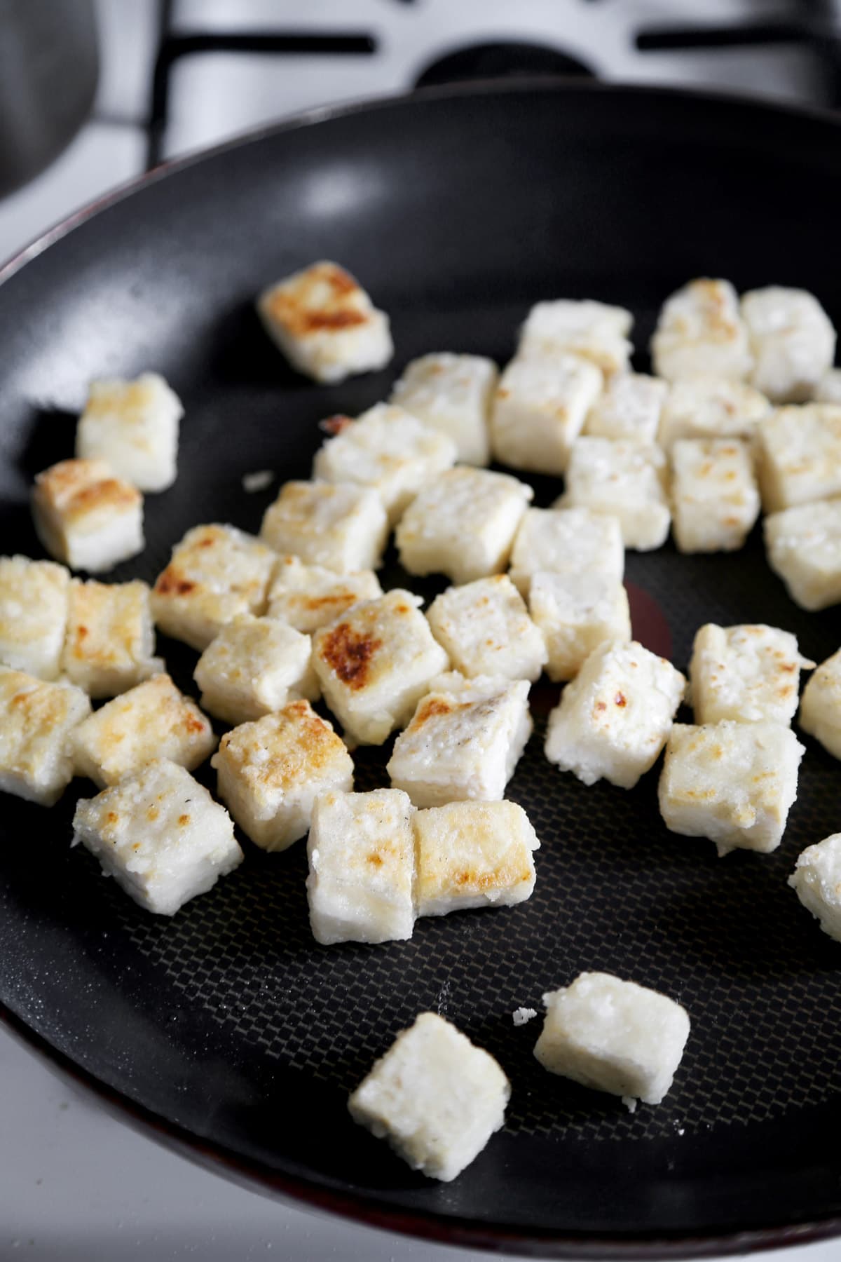 tofu frying in a pan